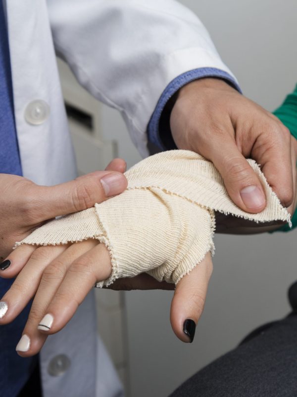 close-up-doctor-bandaging-arm