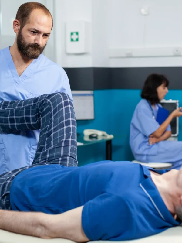 orthopedic-specialist-assisting-old-patient-with-leg-joint-injury